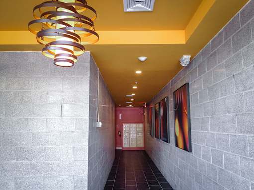 Residential hallway with decorative lighting and mailboxes at 68 Beale Apartments, Quincy, 02169